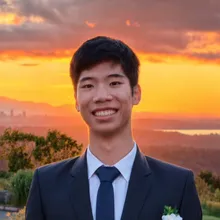 Ray Zhao smiling outdoors at sunset